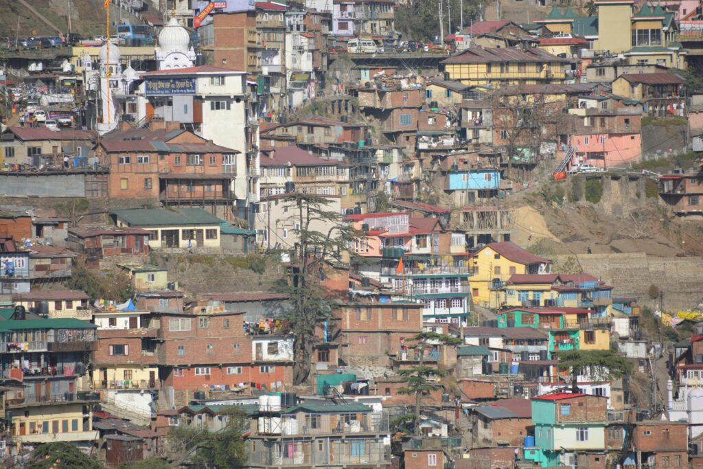 Colorful hillside homes in Shimla, Himachal Pradesh showcasing the unique architecture and vibrant community.